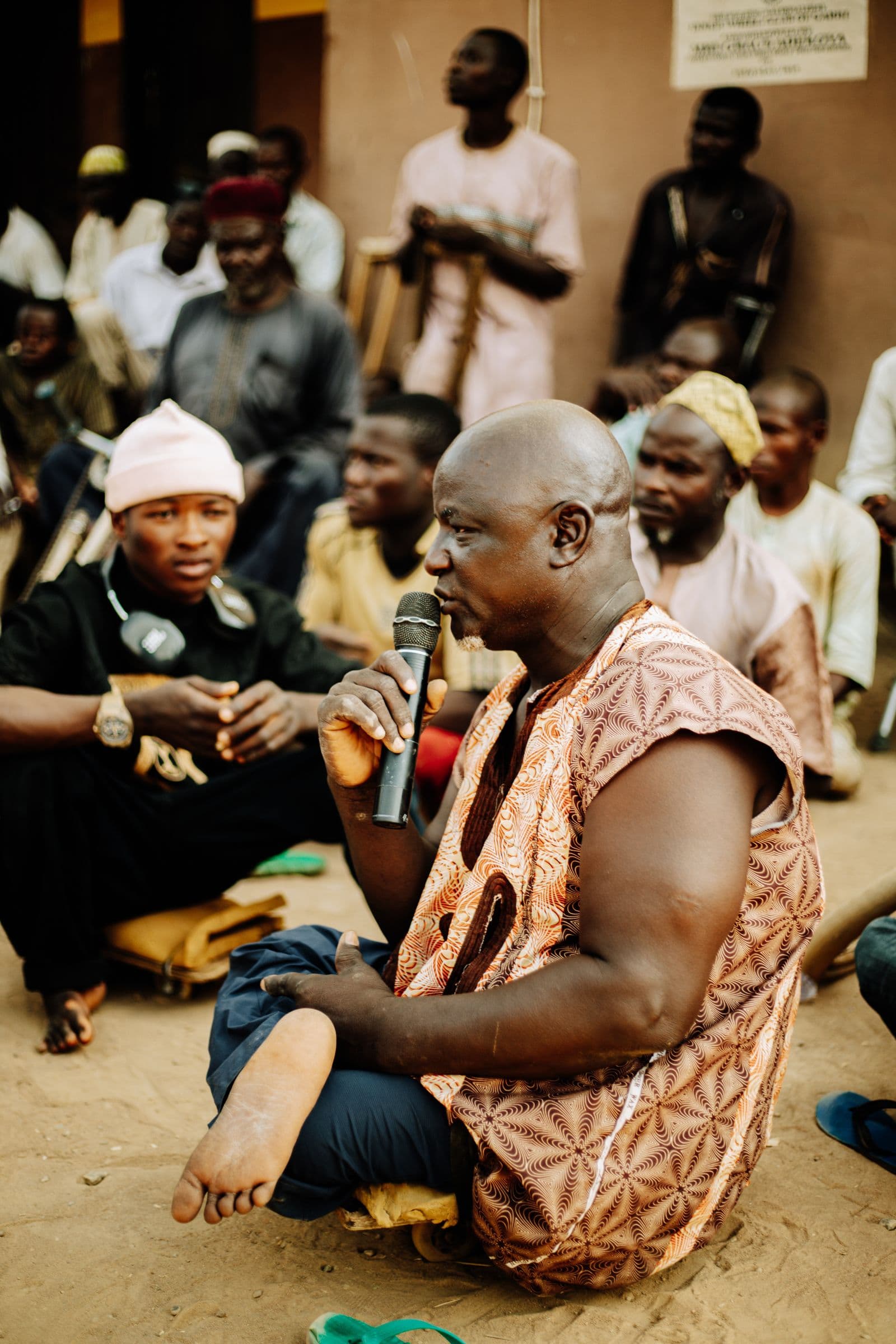 A community member speaks to a gathered group during a local dialogue session