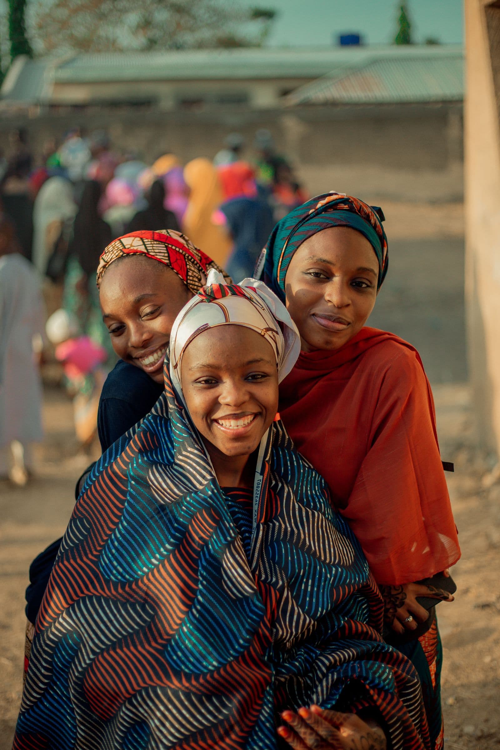 Community members smiling together outdoors in Nigeria